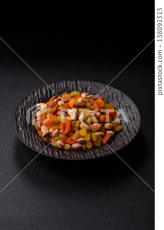 A mix of nuts and dried fruits as ingredients for a healthy meal. Nuts and dried fruits A mix of nuts and dried fruits as ingredients for a healthy meal. Nuts and dried fruits 138091515