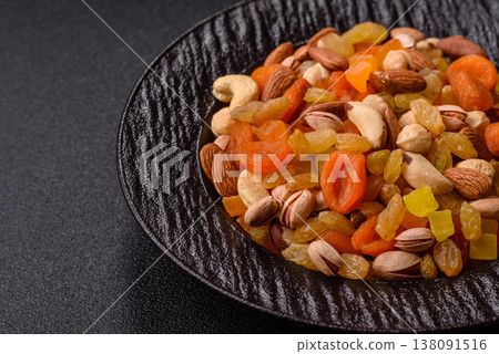 A mix of nuts and dried fruits as ingredients for a healthy meal. Nuts and dried fruits A mix of nuts and dried fruits as ingredients for a healthy meal. Nuts and dried fruits 138091516