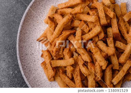 Croutons or crackers made from rye bread with garlic, salt, and spices. Croutons with salt Croutons or crackers made from rye bread with garlic, salt, and spices. Croutons with salt 138091529