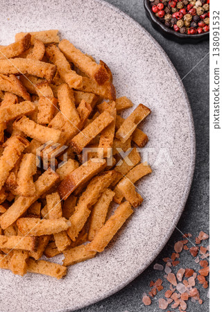 Croutons or crackers made from rye bread with garlic, salt, and spices. Croutons with salt Croutons or crackers made from rye bread with garlic, salt, and spices. Croutons with salt 138091532