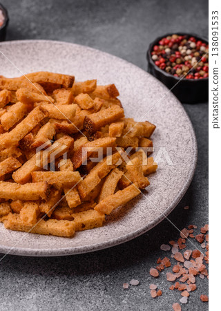 Croutons or crackers made from rye bread with garlic, salt, and spices. Croutons with salt 138091533