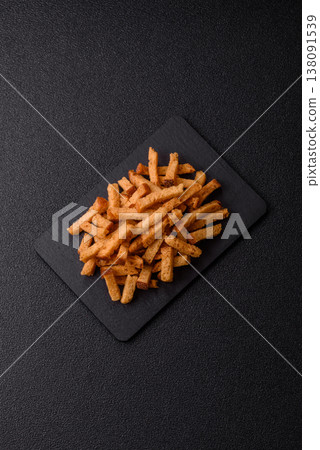Croutons or crackers made from rye bread with garlic, salt, and spices. Croutons with salt Croutons or crackers made from rye bread with garlic, salt, and spices. Croutons with salt 138091539