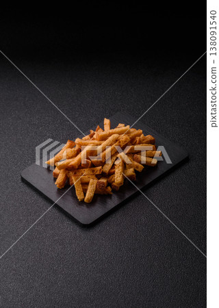Croutons or crackers made from rye bread with garlic, salt, and spices. Croutons with salt Croutons or crackers made from rye bread with garlic, salt, and spices. Croutons with salt 138091540