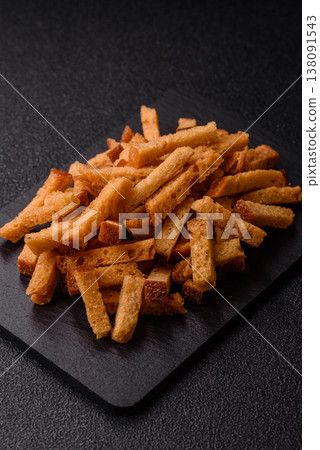Croutons or crackers made from rye bread with garlic, salt, and spices. Croutons with salt Croutons or crackers made from rye bread with garlic, salt, and spices. Croutons with salt 138091543