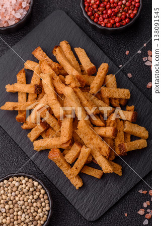 Croutons or crackers made from rye bread with garlic, salt, and spices. Croutons with salt Croutons or crackers made from rye bread with garlic, salt, and spices. Croutons with salt 138091545