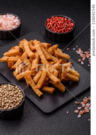 Croutons or crackers made from rye bread with garlic, salt, and spices. Croutons with salt Croutons or crackers made from rye bread with garlic, salt, and spices. Croutons with salt 138091546