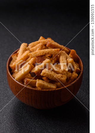 Croutons or crackers made from rye bread with garlic, salt, and spices. Croutons with salt Croutons or crackers made from rye bread with garlic, salt, and spices. Croutons with salt 138091555