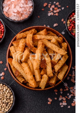 Croutons or crackers made from rye bread with garlic, salt, and spices. Croutons with salt Croutons or crackers made from rye bread with garlic, salt, and spices. Croutons with salt 138091557