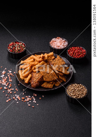 Croutons or crackers made from rye bread with garlic, salt, and spices. Croutons with salt Croutons or crackers made from rye bread with garlic, salt, and spices. Croutons with salt 138091564