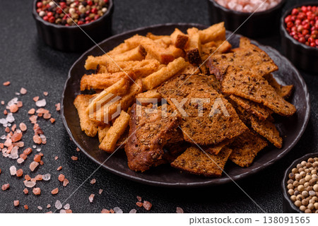 Croutons or crackers made from rye bread with garlic, salt, and spices. Croutons with salt Croutons or crackers made from rye bread with garlic, salt, and spices. Croutons with salt 138091565