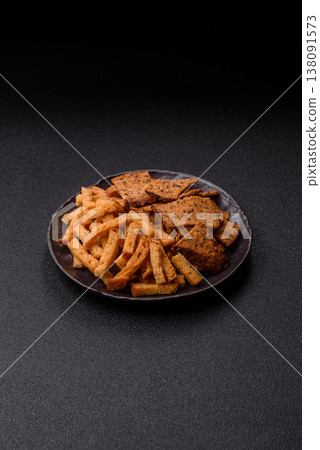 Croutons or crackers made from rye bread with garlic, salt, and spices. Croutons with salt Croutons or crackers made from rye bread with garlic, salt, and spices. Croutons with salt 138091573