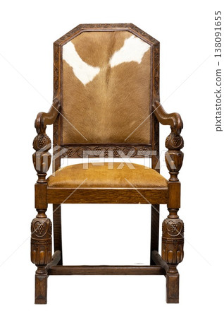 Ornate wooden chair with cowhide upholstery showcasing craftsmanship and vintage charm in a warm, inviting space Ornate wooden chair with cowhide upholstery showcasing craftsmanship and vintage charm in a warm, inviting space 138091655