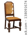 Rustic wooden chair with cowhide seat, showcasing intricate carvings and timeless charm in a cozy rustic setting 138091674