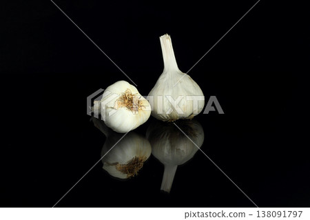 Still life of garlic bulb in dark black background with copy space, It is a herbal food popular Asian. Still life of garlic bulb in dark black background with copy space, It is a herbal food popular Asian. 138091797