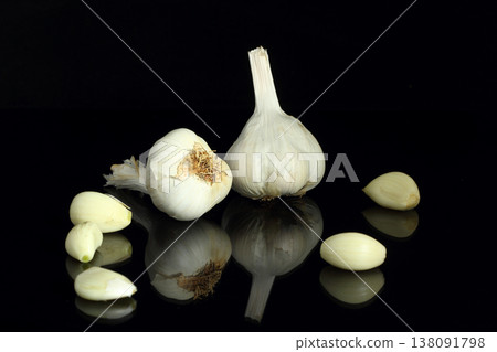 Still life of garlic bulb in dark black background with copy space, It is a herbal food popular Asian. Still life of garlic bulb in dark black background with copy space, It is a herbal food popular Asian. 138091798