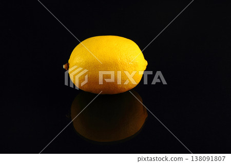 Photo of illuminated lemons with reflection on dark background Photo of illuminated lemons with reflection on dark background 138091807