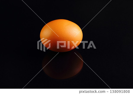 one yellow chicken egg on a black background one yellow chicken egg on a black background 138091808