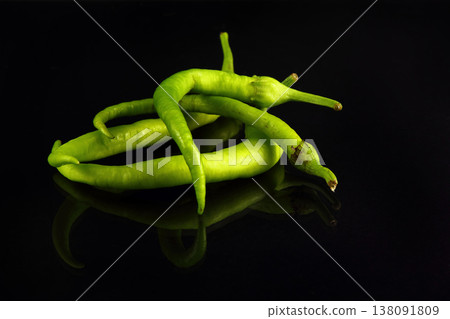 Green chili peppers on black background. Close up 138091809