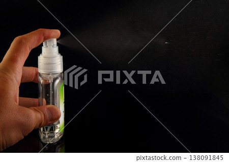 A Person's Hand Spraying Breath Freshener On Black Background 138091845