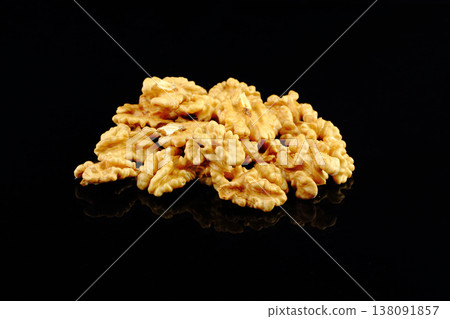 Walnuts with yellow autumn leaves isolated on black background Walnuts with yellow autumn leaves isolated on black background 138091857