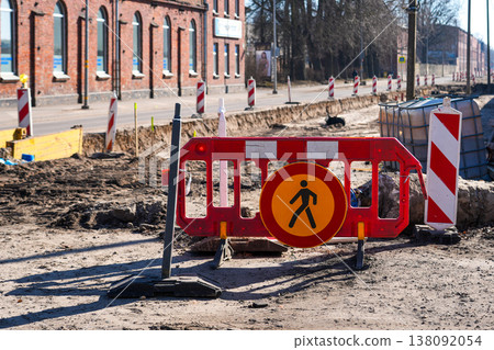 Road construction site with warning barriers and pedestrian sign in urban street reconstruction Road construction site with warning barriers and pedestrian sign in urban street reconstruction 138092054