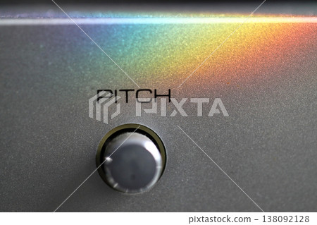 Using a pitch wheel on a MIDI musical keyboard. with rainbow colors. 138092128