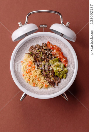 A bowl with beef, porridge, mushrooms, vegetables, sauce, and spices. Beef bowl A bowl with beef, porridge, mushrooms, vegetables, sauce, and spices. Beef bowl 138092187