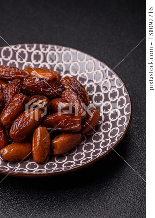 Dried dates on a ceramic plate for Ramadan or Iftar. Dates fruit as a background Dried dates on a ceramic plate for Ramadan or Iftar. Dates fruit as a background 138092216