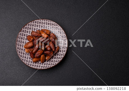 Dried dates on a ceramic plate for Ramadan or Iftar. Dates fruit as a background Dried dates on a ceramic plate for Ramadan or Iftar. Dates fruit as a background 138092218
