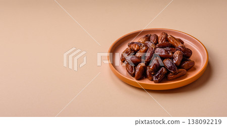 Dried dates on a ceramic plate for Ramadan or Iftar. Dates fruit as a background 138092219