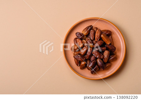 Dried dates on a ceramic plate for Ramadan or Iftar. Dates fruit as a background 138092220