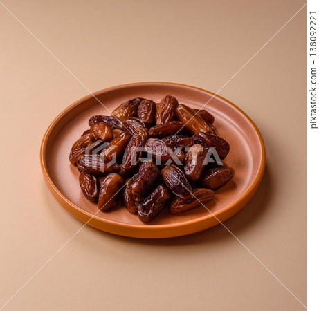 Dried dates on a ceramic plate for Ramadan or Iftar. Dates fruit as a background Dried dates on a ceramic plate for Ramadan or Iftar. Dates fruit as a background 138092221