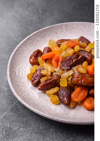 Dried apricots, raisins, and candied fruits as ingredients for baked goods and sweets. Dried fruits Dried apricots, raisins, and candied fruits as ingredients for baked goods and sweets. Dried fruits 138092258