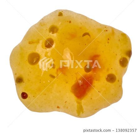 Textured smear of thick mango sauce with spices in light orange color with chili pepper grains on isolated background 138092357