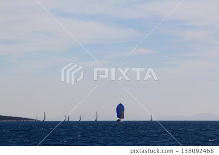 Sailing ship yachts with white sails in race the regatta in the open sea Sailing ship yachts with white sails in race the regatta in the open sea 138092468