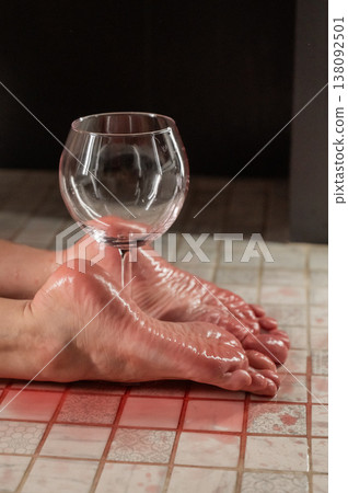 Foot fetish. A woman holds a wine glass in the shower. Foot fetish. A woman holds a wine glass in the shower. 138092501