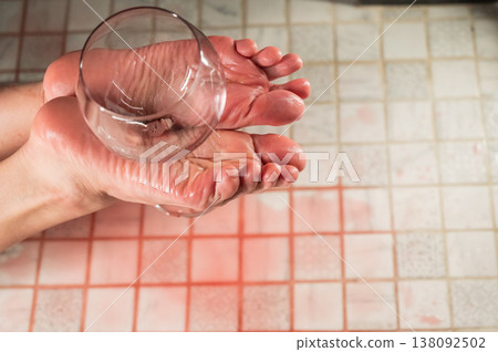 Foot fetish. A woman holds a wine glass in the shower. Foot fetish. A woman holds a wine glass in the shower. 138092502