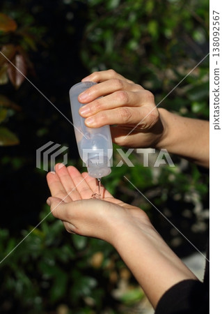 COVID-19 Pandemic Coronavirus woman hands using wash hand sanitizer gel dispenser, against Novel coronavirus (2019-nCoV) or Wuhan coronavirus in city street. Antiseptic, Hygiene and Healthcare concept COVID-19 Pandemic Coronavirus woman hands using wash hand sanitizer gel dispenser, against Novel coronavirus (2019-nCoV) or Wuhan coronavirus in city street. Antiseptic, Hygiene and Healthcare concept 138092567