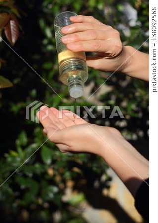 COVID-19 Pandemic Coronavirus woman hands using wash hand sanitizer gel dispenser, against Novel coronavirus (2019-nCoV) or Wuhan coronavirus in city street. Antiseptic, Hygiene and Healthcare concept COVID-19 Pandemic Coronavirus woman hands using wash hand sanitizer gel dispenser, against Novel coronavirus (2019-nCoV) or Wuhan coronavirus in city street. Antiseptic, Hygiene and Healthcare concept 138092568
