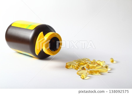Omega 3 yellow capsules and pill bottle on white background Omega 3 yellow capsules and pill bottle on white background 138092575