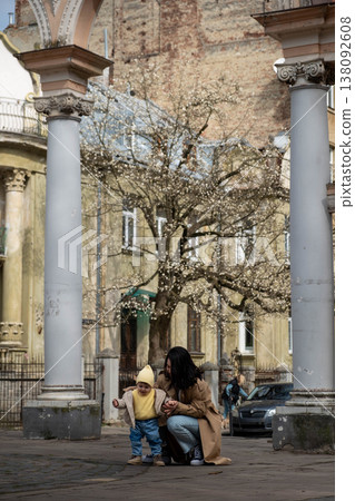 Mother and toddler under blossoming tree 138092608