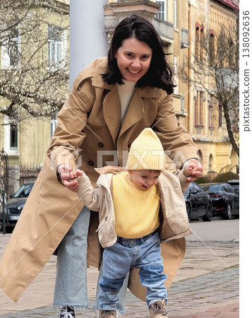 Mother and toddler under blossoming tree Mother and toddler under blossoming tree 138092636