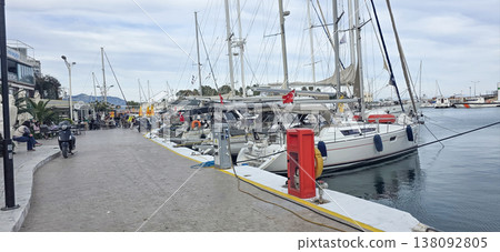 Marina with yachts and boats docked along waterfront promenade in Greece Marina with yachts and boats docked along waterfront promenade in Greece 138092805