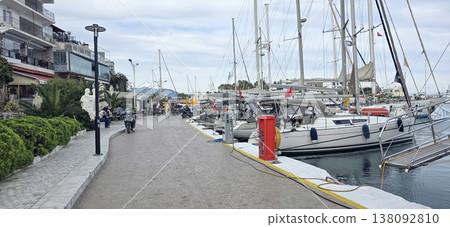 Scenic marina view with yachts and waterfront promenade in coastal town Scenic marina view with yachts and waterfront promenade in coastal town 138092810