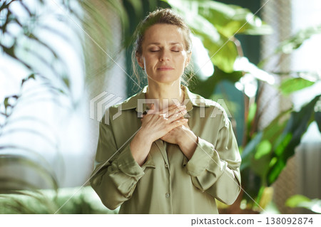 Mindful Woman Practicing Heart-Centered Meditation at Home Mindful Woman Practicing Heart-Centered Meditation at Home 138092874