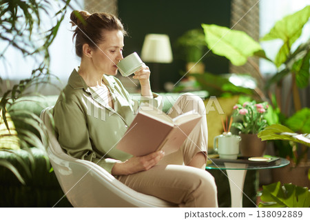 Woman Relaxing with Tea and Book in Sunlit Room 138092889