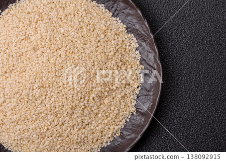 White sesame seeds in a bowl, an ingredient for oil and healthy eating. White sesame White sesame seeds in a bowl, an ingredient for oil and healthy eating. White sesame 138092915