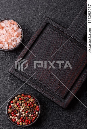 An empty wooden cutting board with cutlery on a kitchen counter. A wooden cutting board An empty wooden cutting board with cutlery on a kitchen counter. A wooden cutting board 138092987