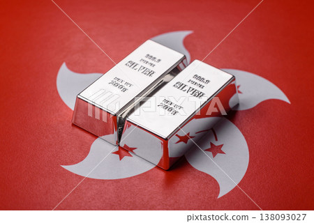 A silver bar, white metal against a backdrop of hong kong flag, as a concept. A silver bar A silver bar, white metal against a backdrop of hong kong flag, as a concept. A silver bar 138093027