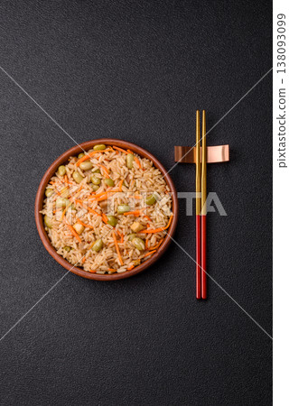 Asian food with rice, edamame, carrots, tofu, and spices. Rice with edamame and carrots Asian food with rice, edamame, carrots, tofu, and spices. Rice with edamame and carrots 138093099